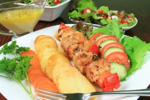 Shish kebab, fried potato rings, cucumber, tomato - delicious food